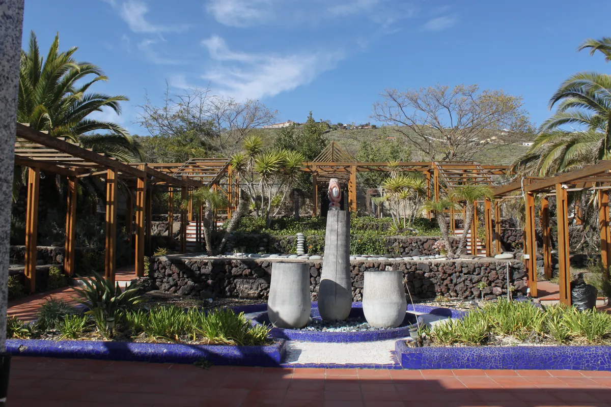 Landscaped garden with a timber pergola, palms and a water feature, Tenerife