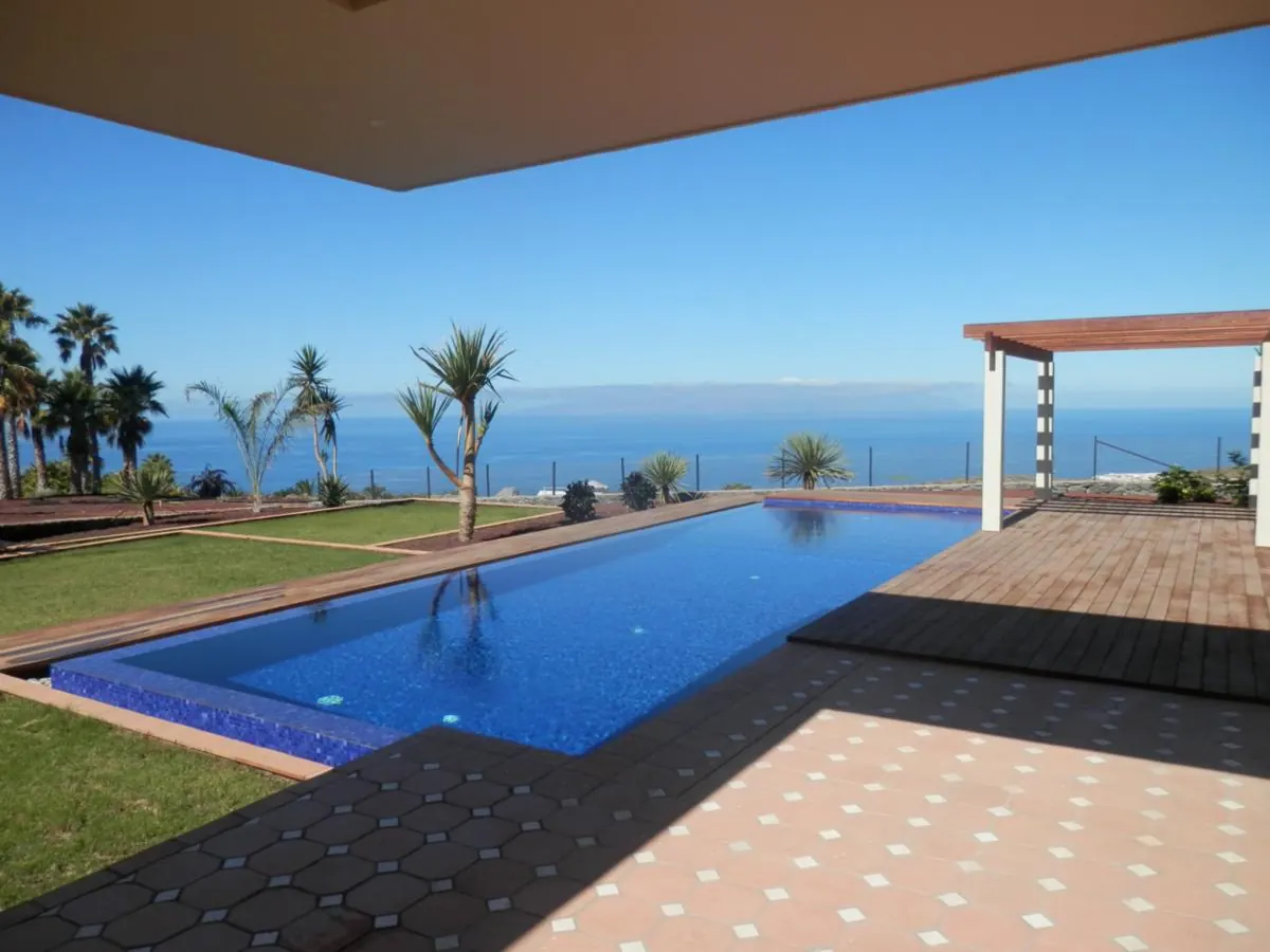 Villa terrace, lawn and swimming pool looking out to sea in Tenerife Villa terrace, lawn and swimming pool looking out to sea in Tenerife